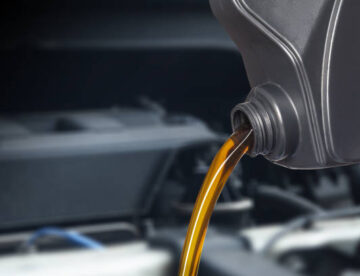 Motor oil pouring, Pouring oil lubricant motor car from bottle