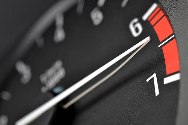 Tachometer or rev counter red lining. Close up focus on the needle tip.