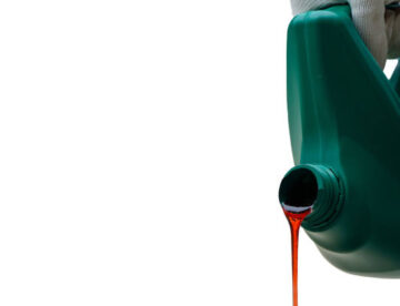 Pour a brand new  clean synthetic engine oil isolated on white,Periodic oil change concept,Plastic canister with synthetic oil